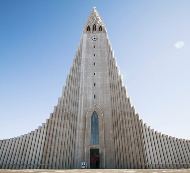The Hallgrimskirkja church tower stands tall in Reykjavik Iceland under a clear blue sky
