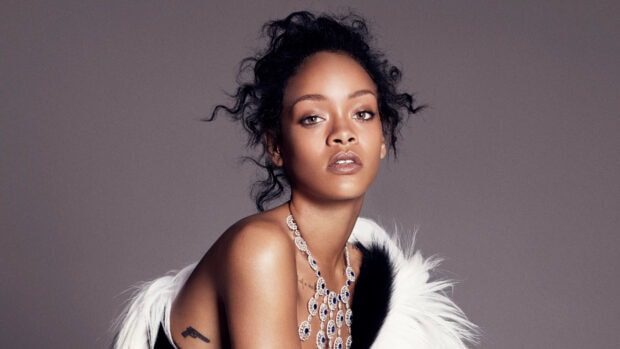 Rihanna wearing a statement necklace with tattoos visible in a high quality portrait