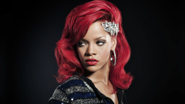 Rihanna with red hair and a decorative hair clip looking to the side in a high quality 4K Rihanna wallpaper
