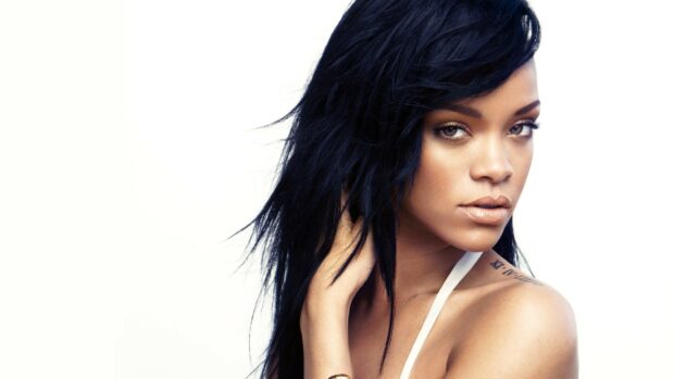 Rihanna close up portrait with striking eyes and tattoos on her shoulder