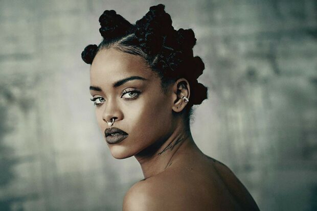 Rihanna with unique hairstyle and septum piercing looking over her shoulder confidently