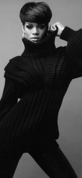 Rihanna wearing a black turtleneck sweater posing confidently in a black and white photo