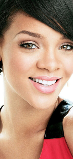 Close up of Rihanna smiling with flawless makeup and short hair style