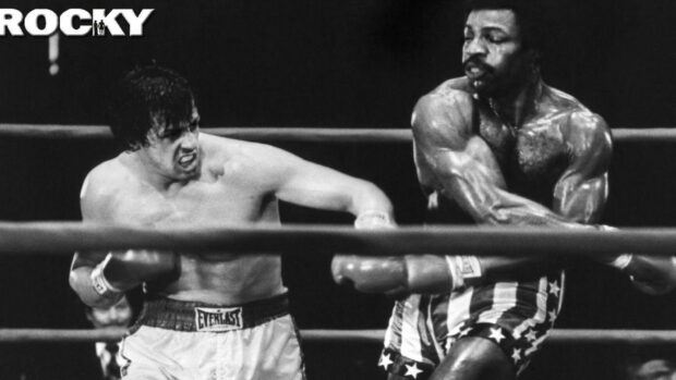 Rocky delivering a powerful punch in a boxing match with an intense opponent