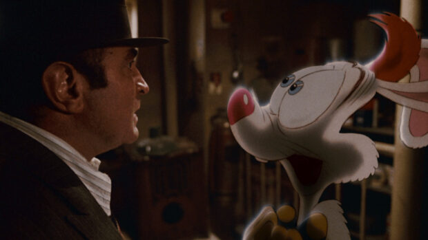 A man in a hat looking at Roger Rabbit with a surprised expression