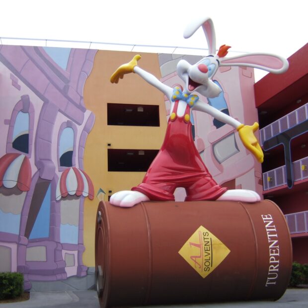 Roger Rabbit statue standing on a large drum with colorful cartoon background