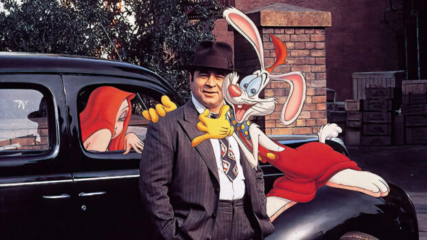 A man in a suit stands next to Roger Rabbit with Jessica Rabbit inside a vintage black car