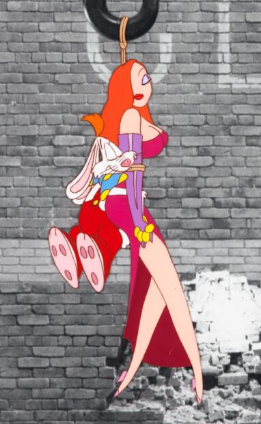 Jessica Rabbit holding Roger Rabbit tied up against a brick wall in a scene from Roger Rabbit
