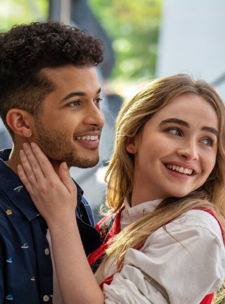 Sabrina Carpenter smiling with a young man in a casual setting