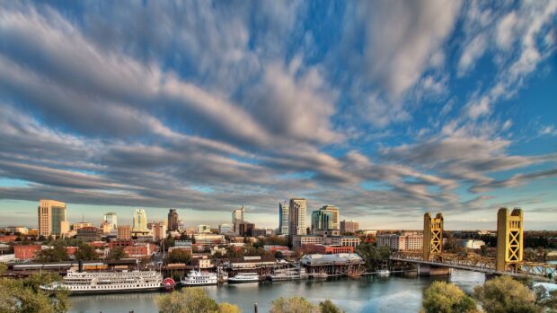 Cityscape of Sacramento skyline with Tower Bridge over river and historic boats