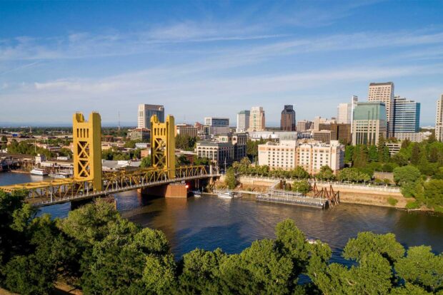 The Sacramento cityscape with the iconic tower bridge over the river and surrounding buildings