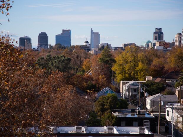 Sacramento cityscape with autumn trees and downtown skyline in clear daylight