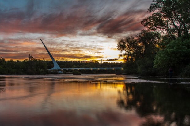 Sacramento river at sunset with modern bridge and colorful sky in Sacramento