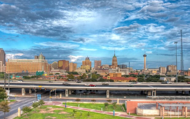 San Antonio skyline with highway and cloudy blue sky in Texas cityscape view