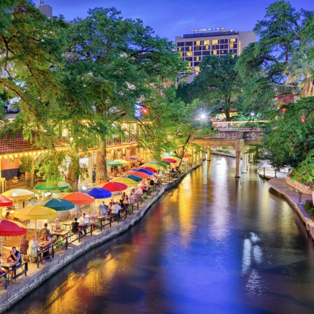 Evening view of colorful umbrellas along the San Antonio riverwalk in Texas