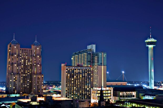 Night view of San Antonio cityscape with illuminated buildings and tower