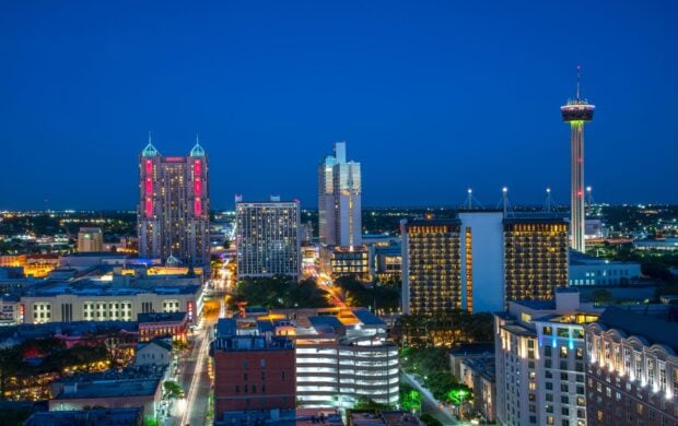 Nighttime cityscape of San Antonio Texas illuminated with buildings and tower lights