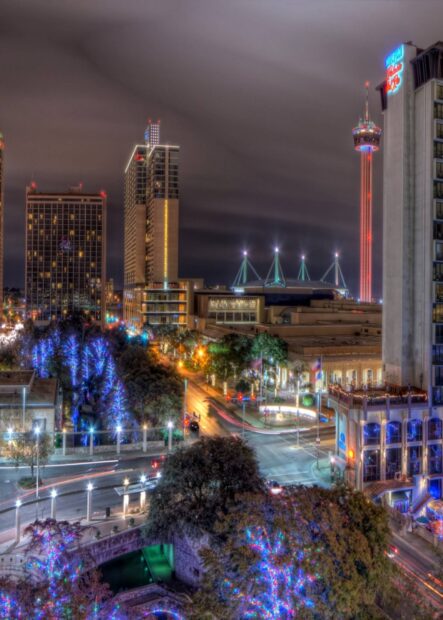 Night cityscape of San Antonio Texas with illuminated buildings and decorated trees