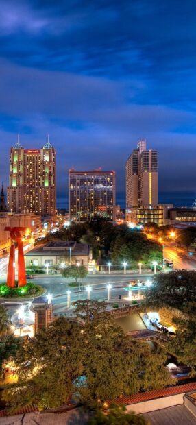 Nighttime view of San Antonio Texas cityscape with illuminated buildings and streets
