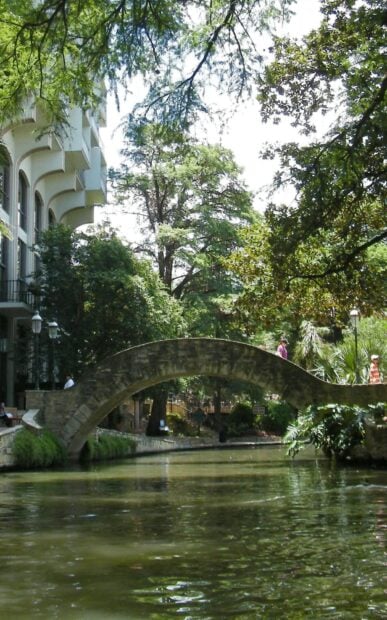 Stone arch bridge over river in San Antonio Texas scenic park