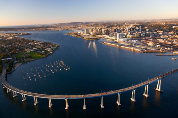 Aerial view of San Diego California cityscape with Coronado Bridge over the bay at sunset