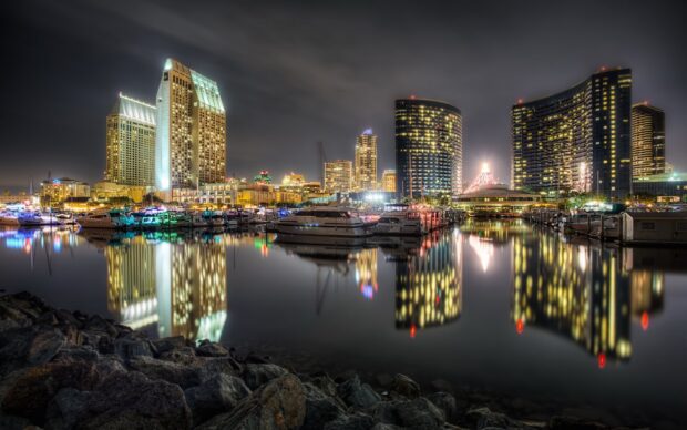 Stunning San Diego California skyline reflected in calm water at night