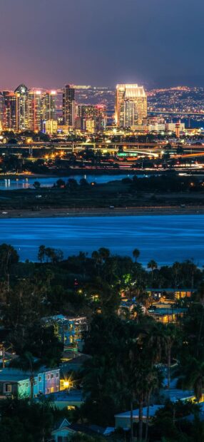 Nighttime cityscape of San Diego California with skyline and water view