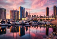 San Diego California city skyline with boats docked at the marina at sunset