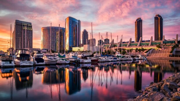 San Diego California city skyline with boats docked at the marina at sunset