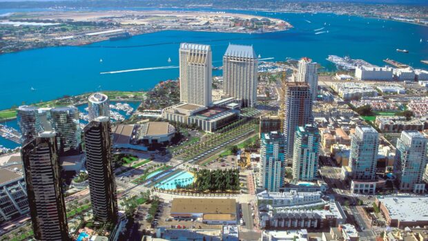 Aerial view of San Diego California waterfront and city skyline with high rise buildings and harbor