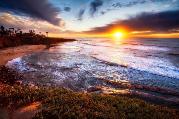 Beautiful San Diego coastline at sunset with vibrant sky and ocean waves