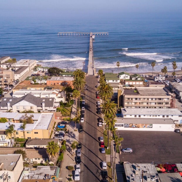 Aerial view of San Diego California pier and palm trees along the street