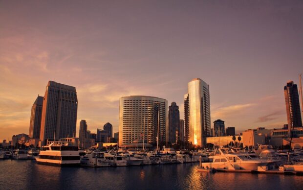 San Diego skyline with marina and sunset reflections on buildings and boats