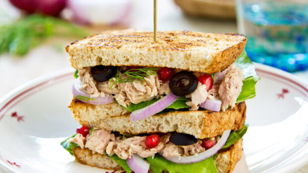 Delicious sandwich with tuna lettuce olives and onions on toasted bread