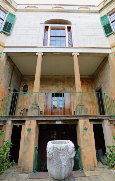 Historic Savannah Georgia building facade with stone planter and columns
