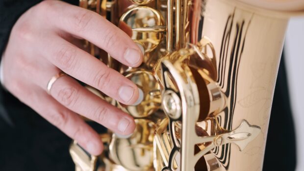 Close up of hand playing saxophone keys showing detailed craftsmanship