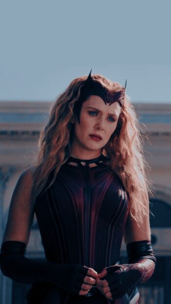 Scarlet Witch wearing her iconic costume and headpiece with a thoughtful expression