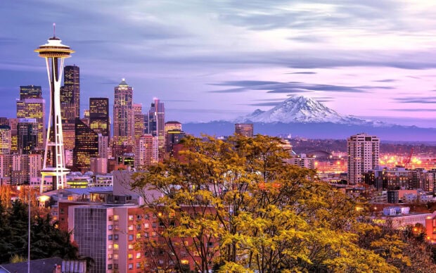 Seattle city skyline with Mount Rainier in the background at dusk