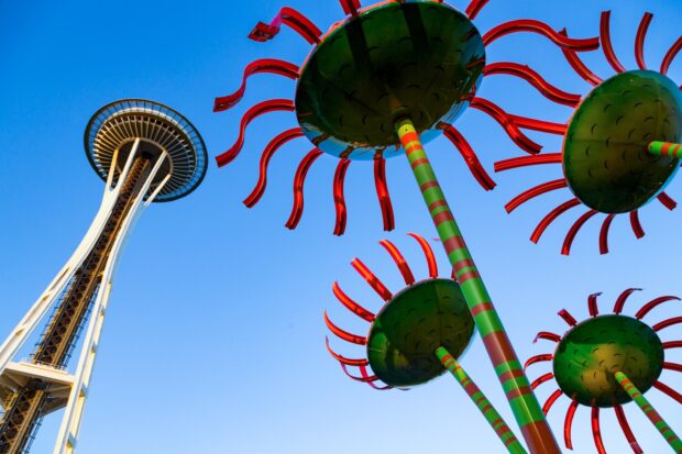 Colorful flower sculptures near the Seattle Space Needle under a clear blue sky
