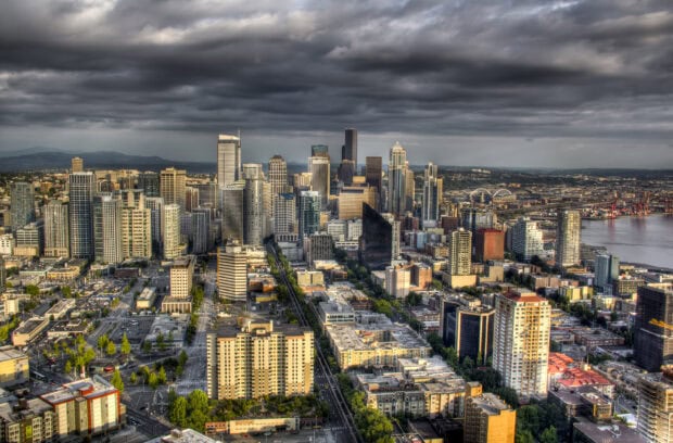 Seattle city skyline with tall buildings under a cloudy sky