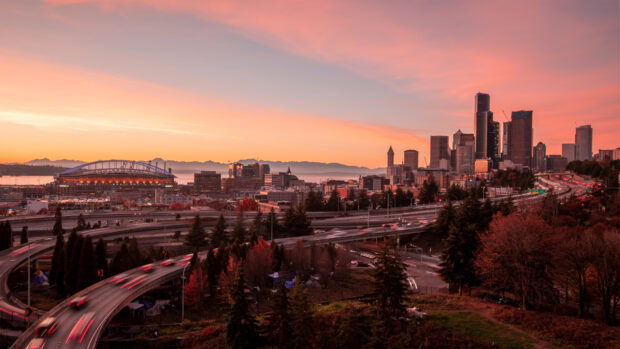 Beautiful Seattle cityscape at sunset with highways and autumn trees surrounding the skyline