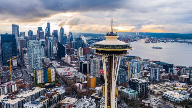 Aerial view of Seattle cityscape featuring the Space Needle and waterfront on a cloudy day