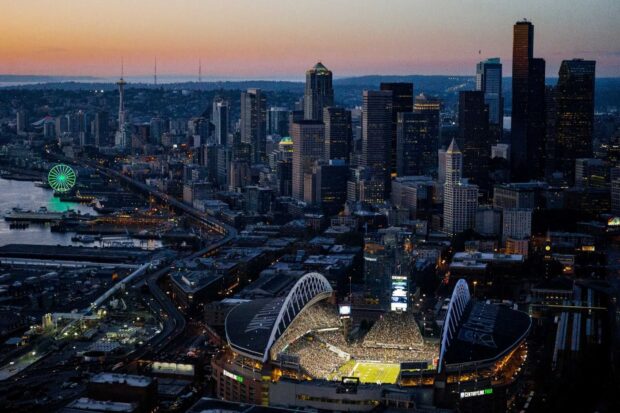 Seattle city skyline with stadium and ferris wheel at sunset in HD quality