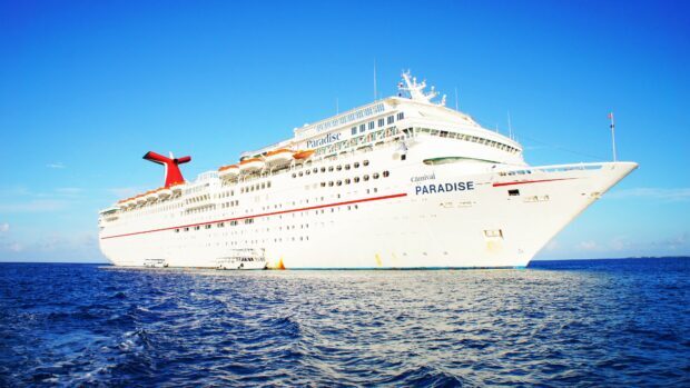 A large passenger ship cruising on the clear blue ocean under a bright sky