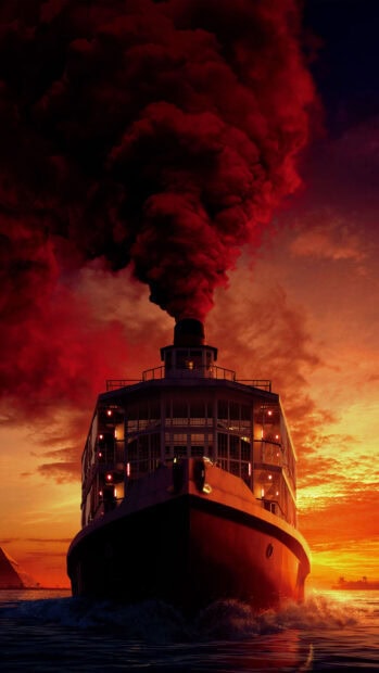 A steam ship releasing thick red smoke at sunset on the ocean