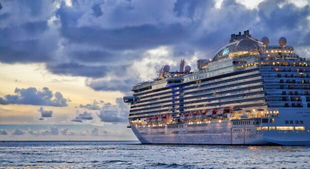 Large ship sailing on the sea under a cloudy sky at dusk