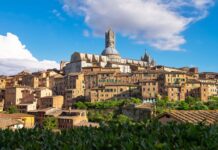 Historic Siena architecture showcasing ancient buildings and cathedral under a blue sky