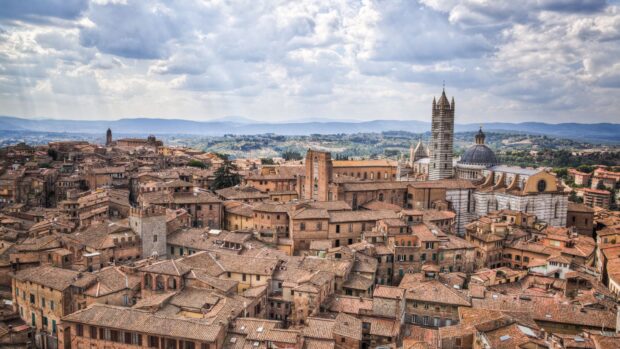 A panoramic view of Siena cityscape showcasing historic architecture and iconic towers in HD quality