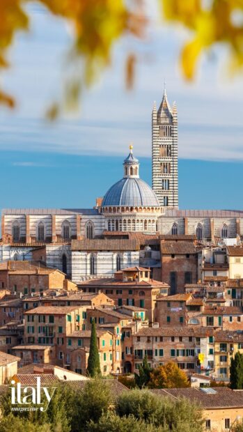Historic Siena cityscape with cathedral dome and tower under a blue sky
