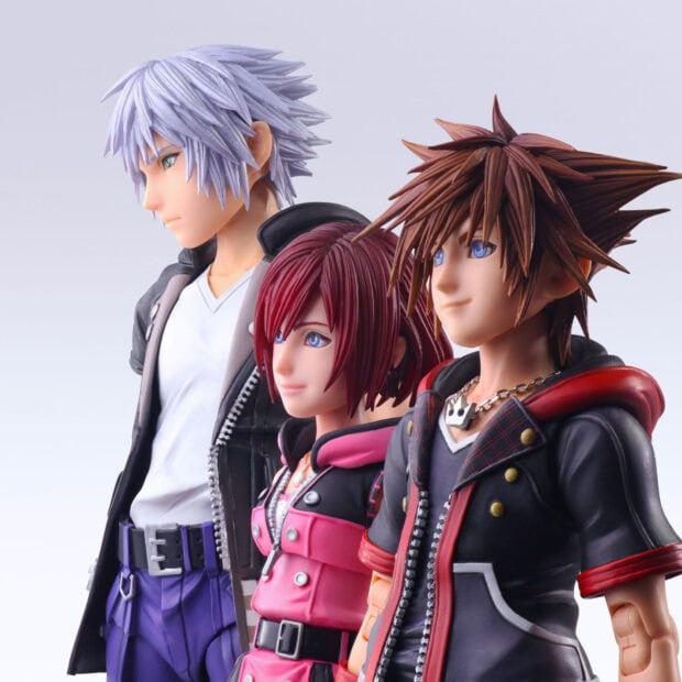 Three Kingdom Hearts characters standing side by side in detailed outfits